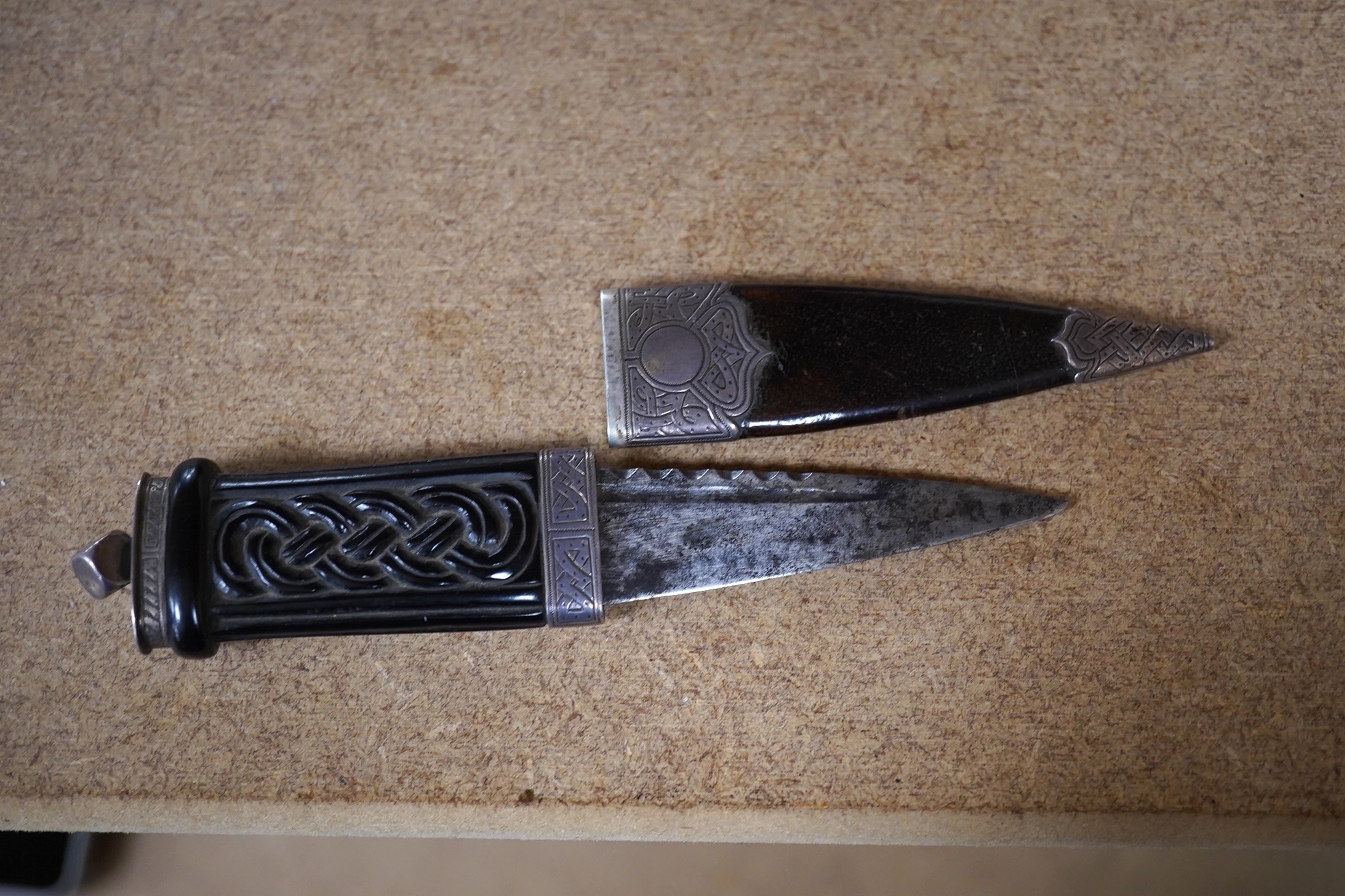 A George V Scottish silver mounted ebony and leather singh dhu, George Paul, Edinburgh, 1919, 16.6cm. Condition - poor